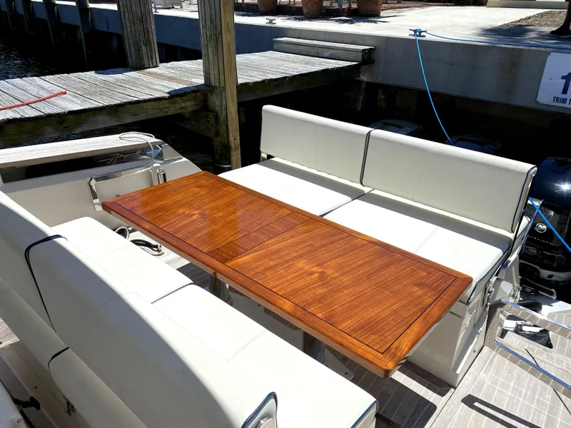 Slide: The Image of Azimut Atlantis Verve Outboard 2014 boat with elegant wooden table and white seating. - 20