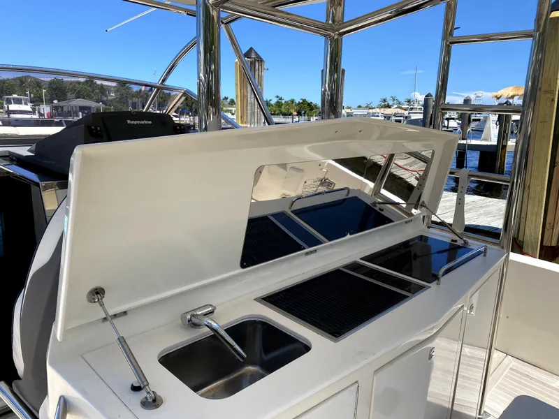Slide: The Image of Azimut Atlantis Verve Outboard 2014 yacht with outdoor kitchen and sink at marina. - 23
