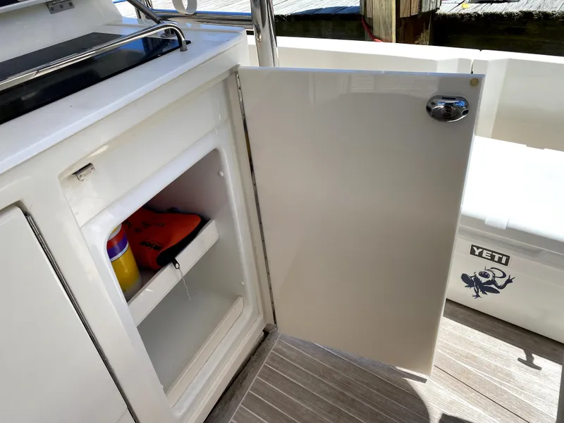 Slide: The Image of Open storage cabinet on 2014 Azimut Atlantis Verve Outboard boat deck. - 25