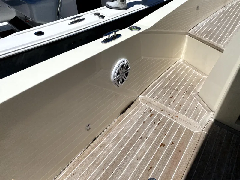 Slide: The Image of Azimut Atlantis Verve Outboard 2014 boat deck with wood flooring and speaker. - 26