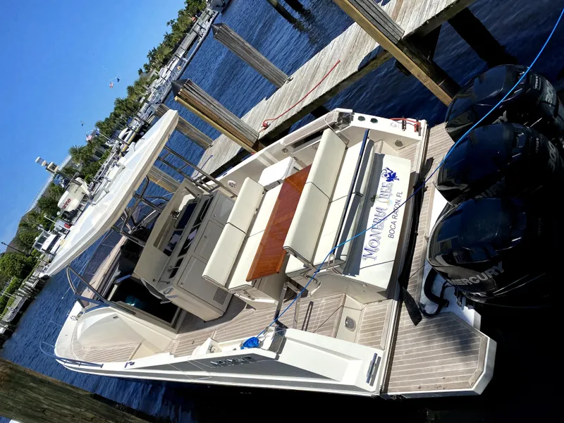 Slide: The Image of Azimut Atlantis Verve Outboard 2014 docked, featuring spacious seating and dual Mercury engines. - 3