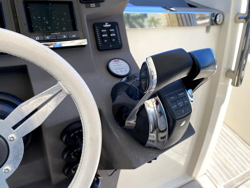Slide: The Image of Azimut Atlantis Verve Outboard 2014 helm with steering wheel and throttle controls. - 33