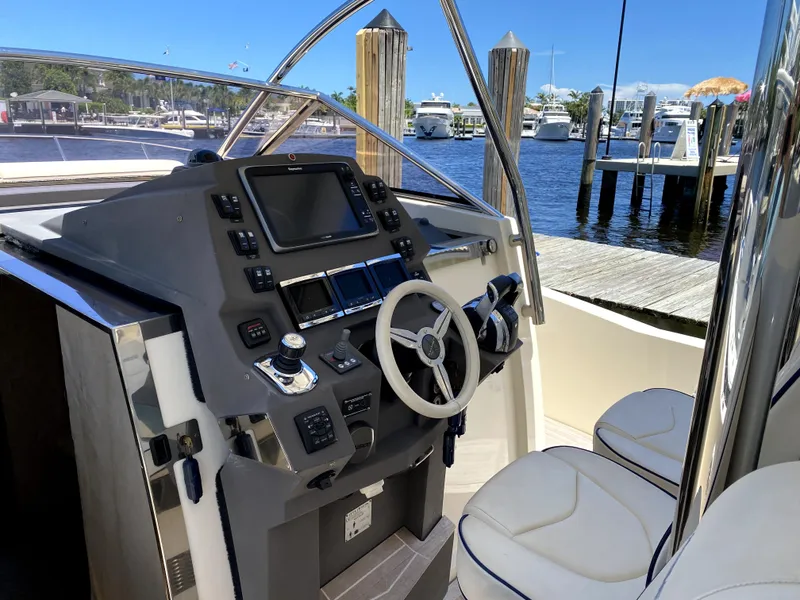 Slide: The Image of Azimut Atlantis Verve Outboard 2014 boat cockpit with steering wheel and control panel. - 36