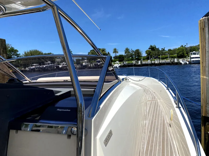 Slide: The Image of Azimut Atlantis Verve Outboard 2014 yacht docked by a scenic waterfront. - 46