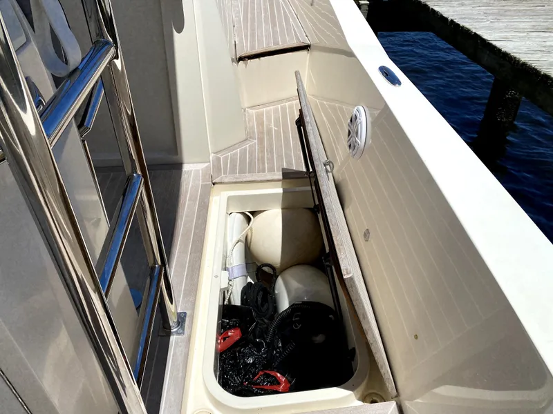 Slide: The Image of Open storage compartment on 2014 Azimut Atlantis Verve Outboard boat deck. - 8
