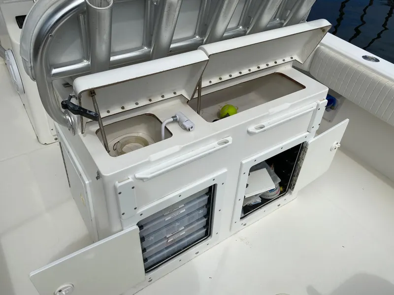 Slide: The Image of 2002 Regulator 32 Forward Seating boat with open storage compartments and seating area. - 11