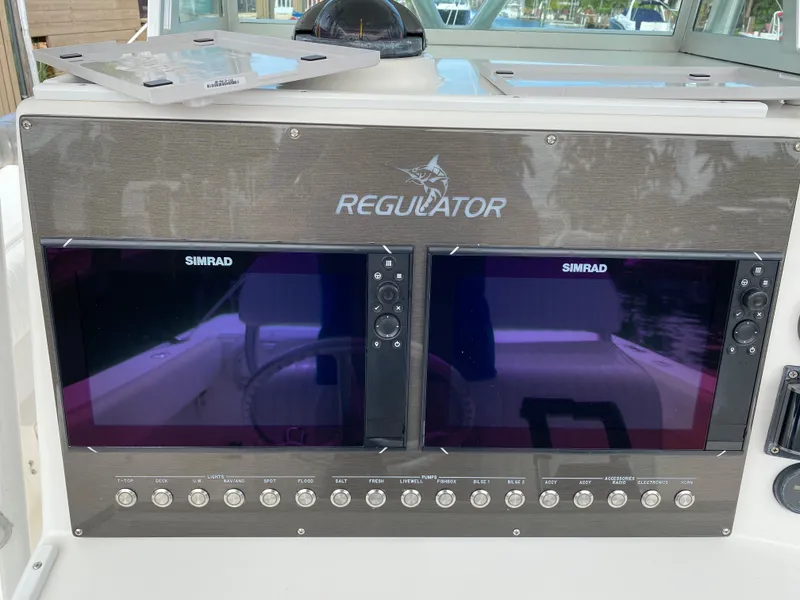 Slide: The Image of Control panel of 2002 Regulator 32 Forward Seating boat with dual Simrad displays. - 13