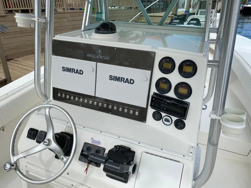 Slide: The Image of Center console of a 2002 Regulator 32 Forward Seating boat with Simrad electronics. - 14