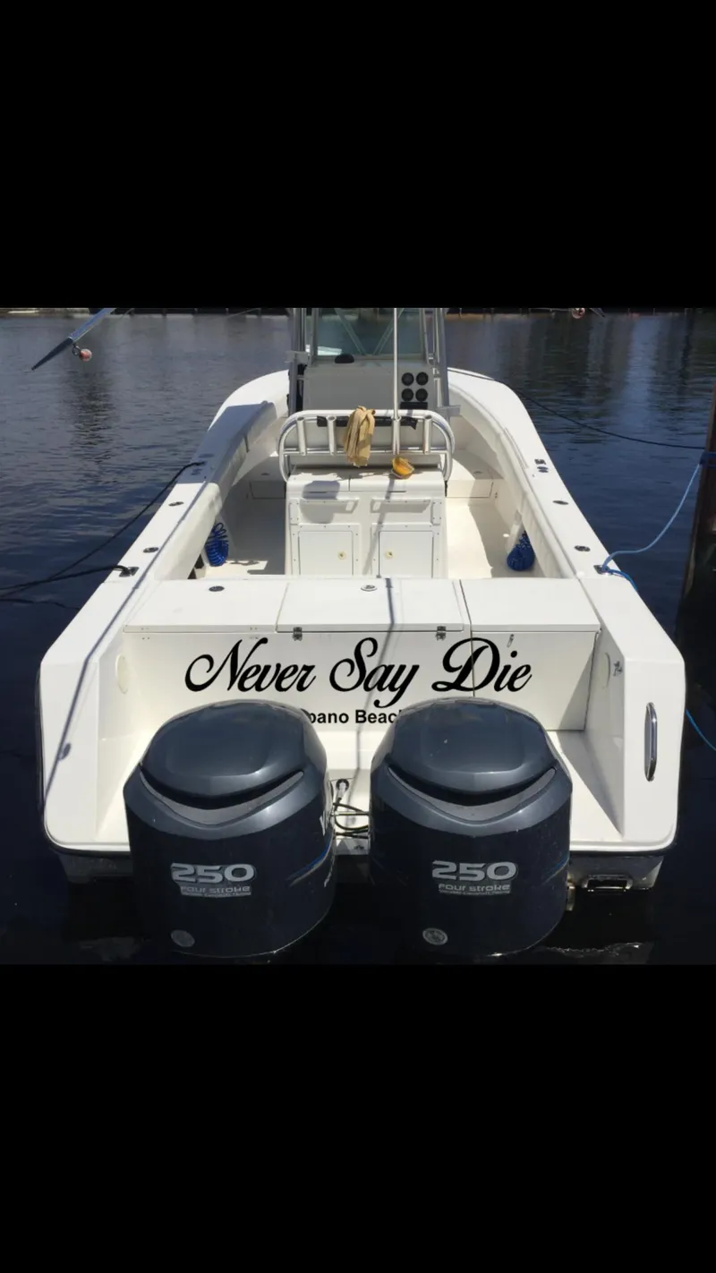 Slide: The Image of 2002 Regulator 32 Forward Seating boat with twin 250 engines, named "Never Say Die." - 18