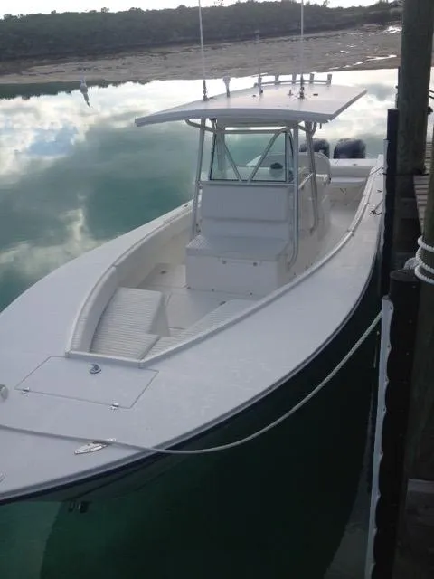 Slide: The Image of 2002 Regulator 32 Forward Seating boat docked on calm water. - 20