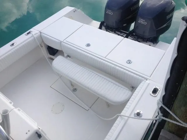 Slide: The Image of 2002 Regulator 32 Forward Seating boat with twin Yamaha 250 engines, docked. - 22