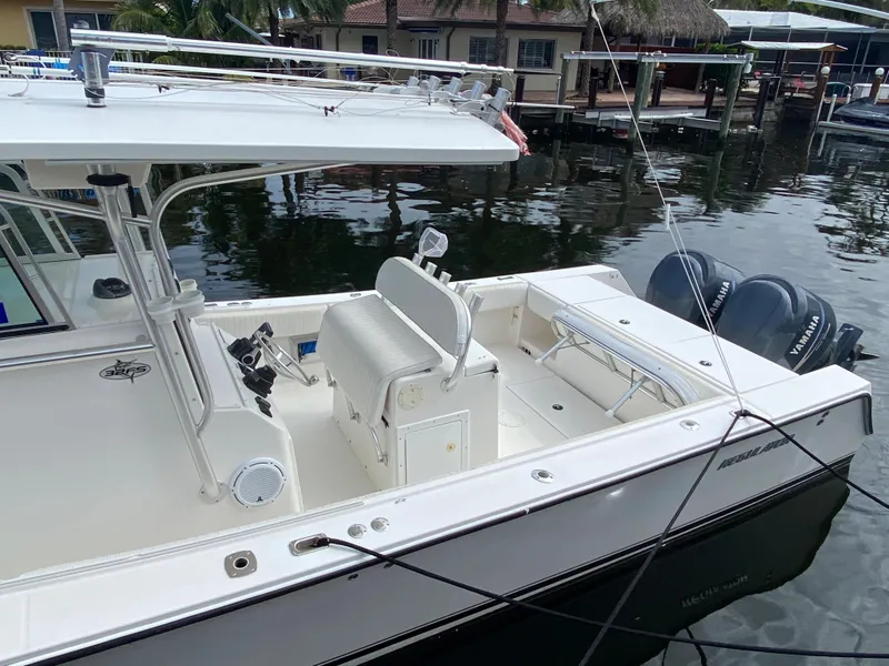 Slide: The Image of 2002 Regulator 32 Forward Seating boat docked with dual engines. - 7