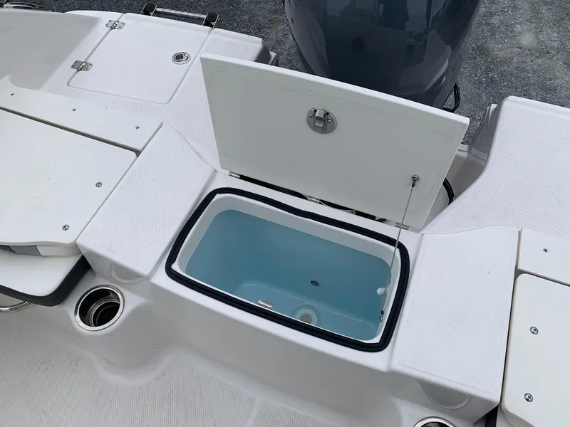 Slide: The Image of 2026 Robalo R200 Center Console boat with open storage compartment. - 6