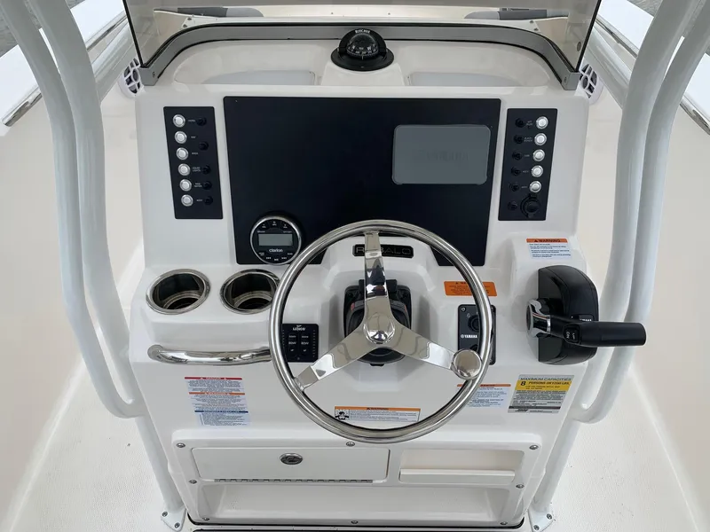 Slide: The Image of 2026 Robalo R200 Center Console dashboard with steering wheel and control panel. - 7