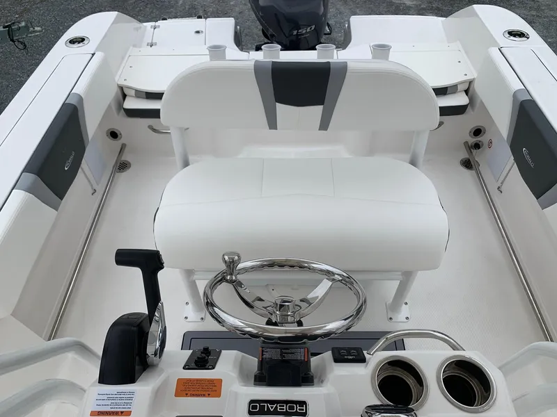 Slide: The Image of 2026 Robalo R200 Center Console boat interior with steering wheel and seating. - 9