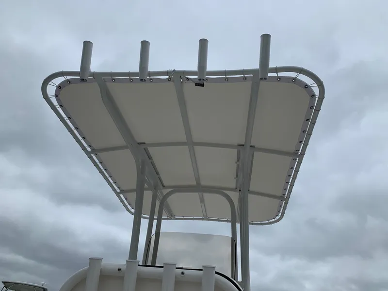 Slide: The Image of 2026 Robalo R200 Center Console boat with T-top against cloudy sky. - 4