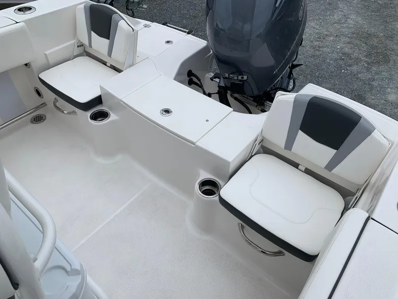 Slide: The Image of 2026 Robalo R200 Center Console boat interior with seating and engine view. - 5