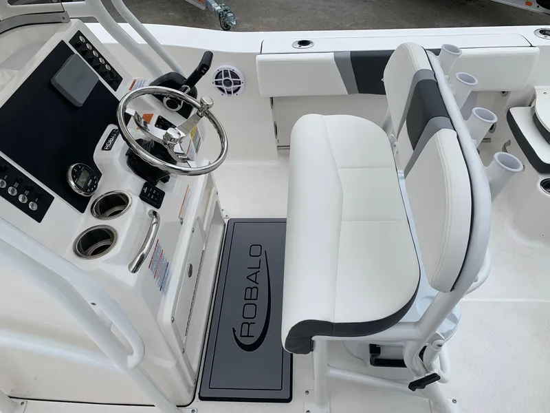 Slide: The Image of 2026 Robalo R200 Center Console boat interior with steering wheel and seating. - 8