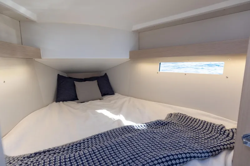 Slide: The Image of Interior of Beneteau Oceanis 34.1, 2026, featuring cozy bed and window. - 7