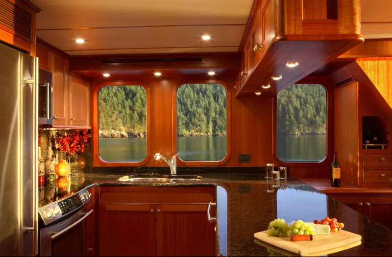 Slide: The Image of Luxurious kitchen in 2025 Northern Marine 64 yacht with scenic window views. - 2
