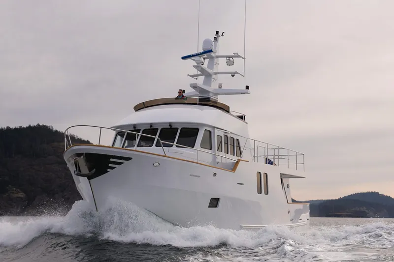 Slide: The Image of Luxury Northern Marine 64 yacht cruising through waves, 2027 model, against a scenic coastal backdrop. - 8