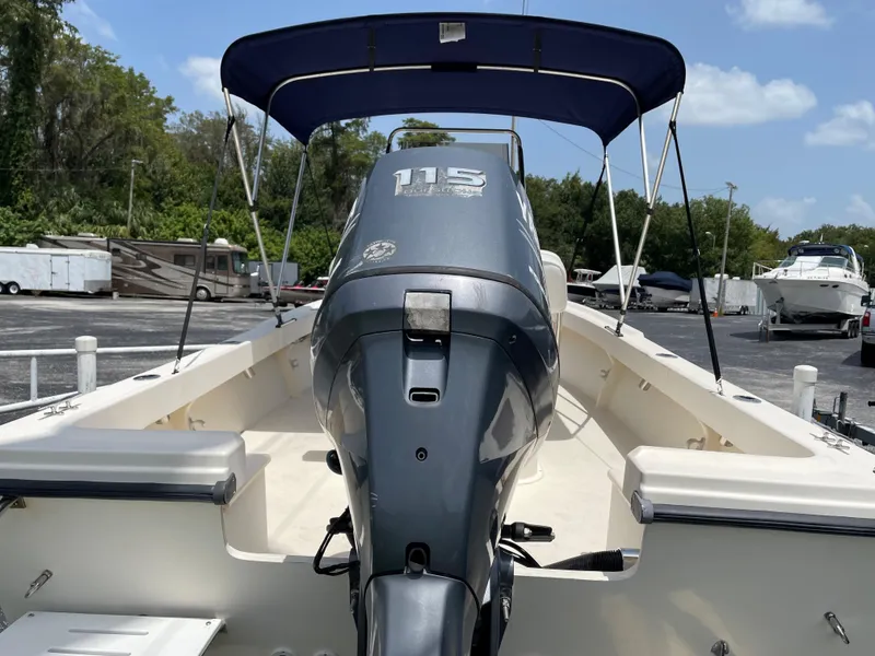 Slide: The Image of 2004 Parker 1801 Center Console boat with 115 HP outboard motor and blue bimini top. - 5
