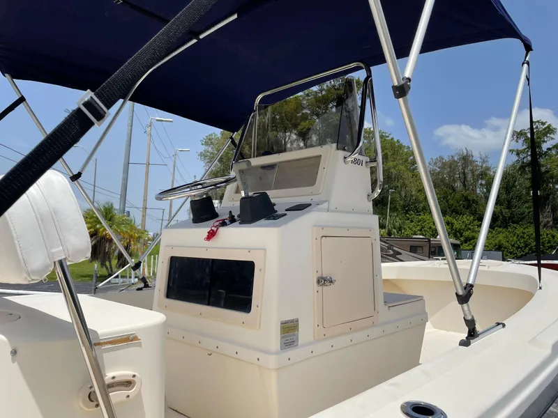 Slide: The Image of 2004 Parker 1801 Center Console boat with canopy on a sunny day. - 8