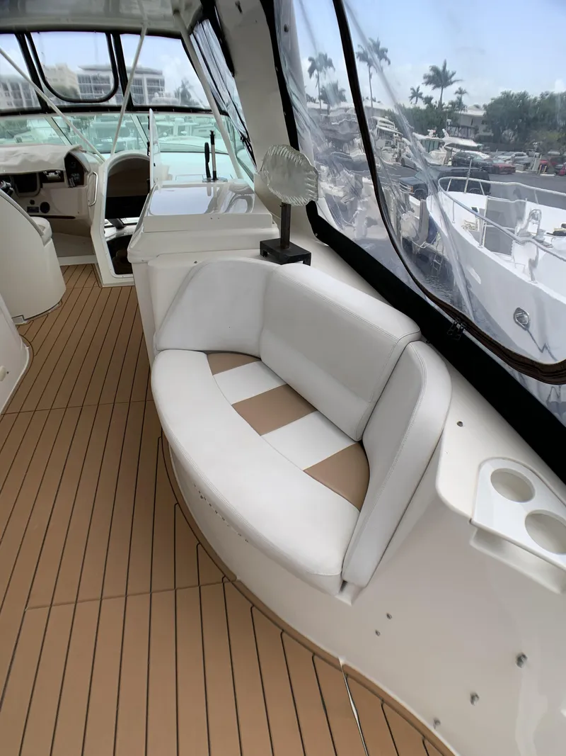 Slide: The Image of 2006 Carver 56 Voyager yacht interior with cushioned seating and teak flooring. - 22