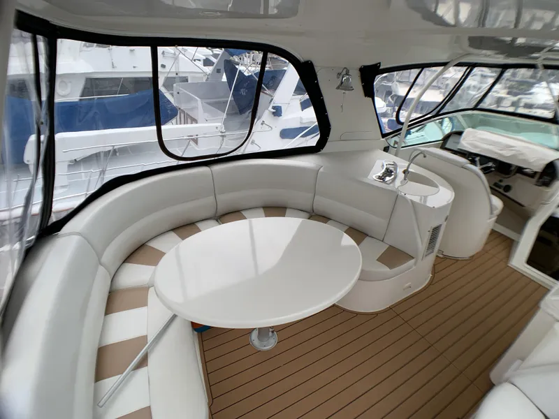 Slide: The Image of 2006 Carver 56 Voyager yacht interior with curved seating and table. - 23