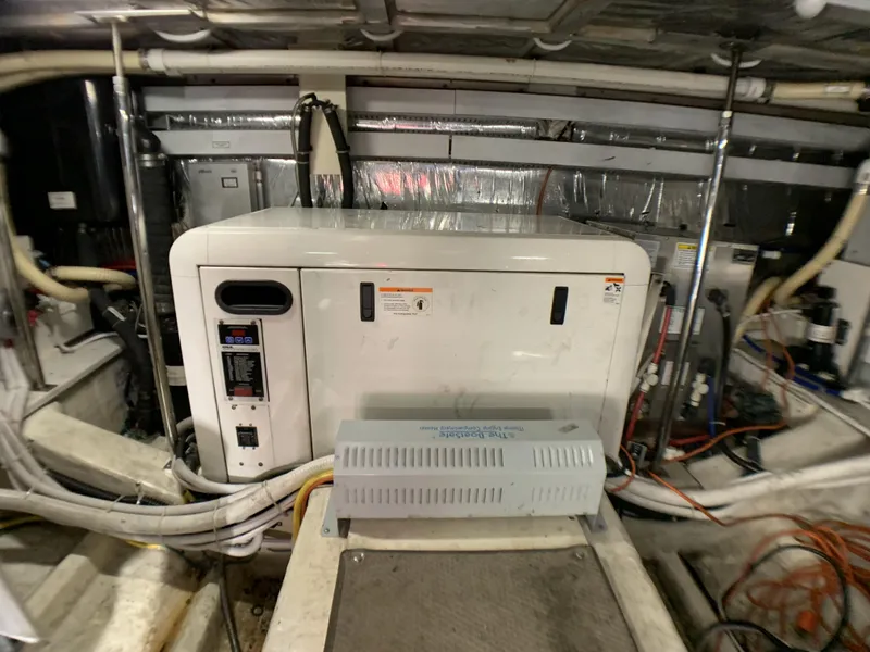 Slide: The Image of Engine room of a 2006 Carver 56 Voyager yacht with generator and wiring. - 35