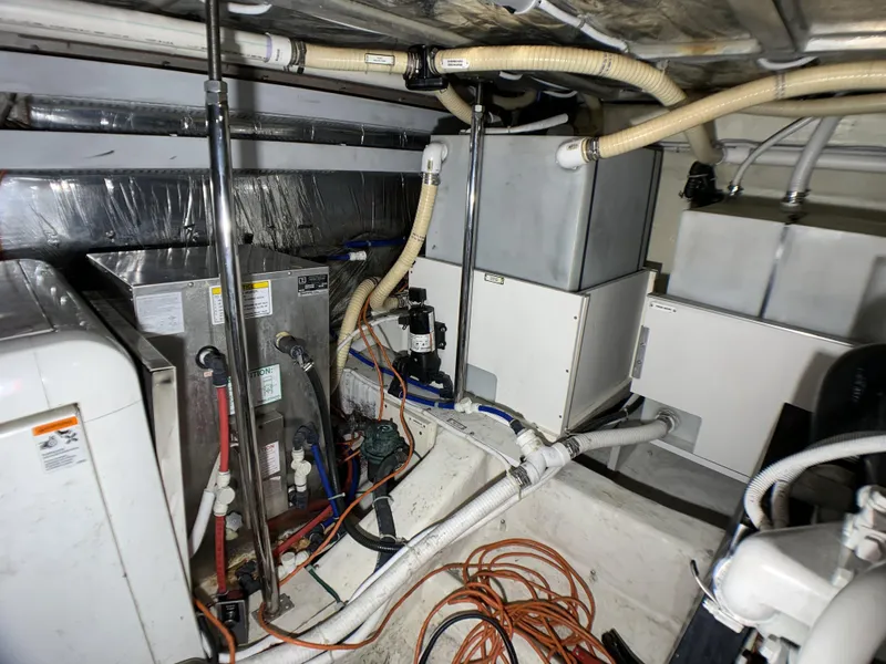 Slide: The Image of Engine room of a 2006 Carver 56 Voyager yacht with various mechanical components. - 39