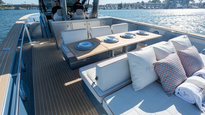 Slide: The Image of Luxurious 2022 Pardo Yachts 43 with elegant deck dining setup on the water. - 14