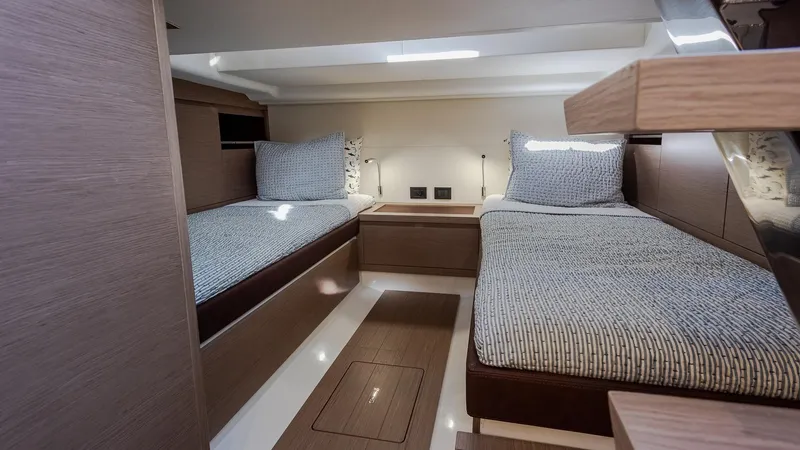 Slide: The Image of Interior of 2022 Pardo Yachts 43, featuring twin beds and modern wood finish. - 27