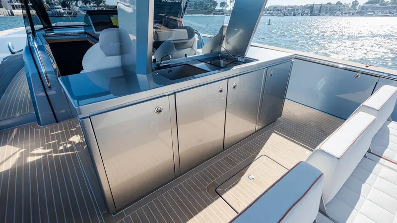 Slide: The Image of Luxurious 2022 Pardo Yachts 43 interior with sleek cabinetry and seating, overlooking serene waters. - 16