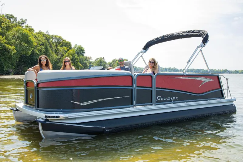 Slide: The Image of 2023 Premier 250 SunSation RE pontoon boat on a lake with passengers. - 0