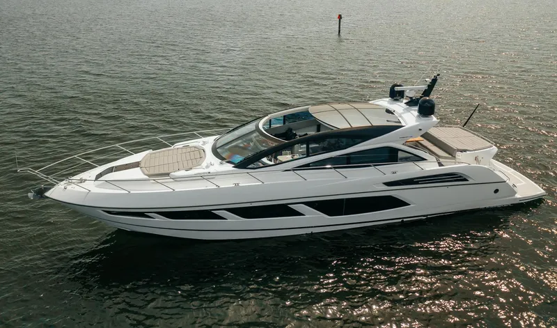 Slide: The Image of 2018 Sunseeker Predator 68 luxury yacht cruising on open water. - 2