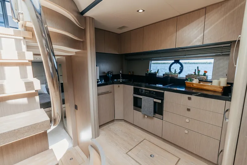 Slide: The Image of Modern kitchen interior of 2018 Sunseeker Predator 68 yacht with wooden cabinetry. - 26