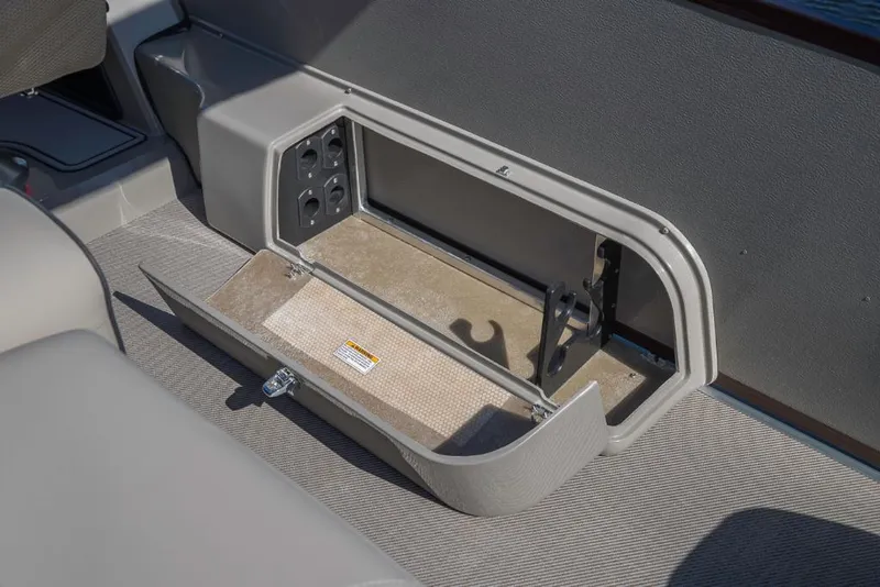 Slide: The Image of 2023 Premier 220 Castaway storage compartment with open lid. - 14