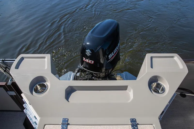 Slide: The Image of 2023 Premier 220 Castaway boat with Suzuki 140 outboard motor on water. - 18