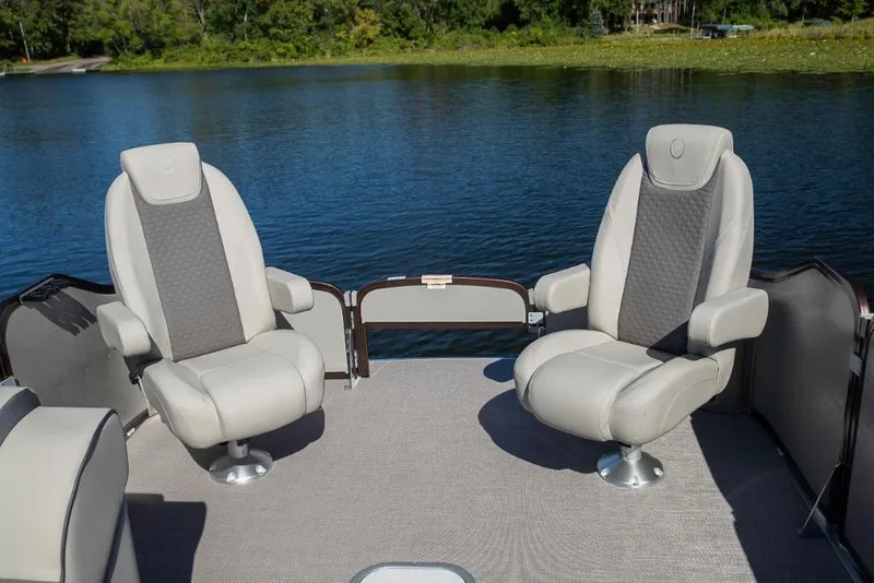 Slide: The Image of 2023 Premier 220 Castaway boat with two comfortable seats on a lake. - 25