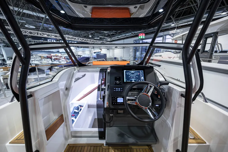Slide: The Image of Interior cockpit of 2025 Nimbus T8 boat with modern dashboard and steering wheel. - 3