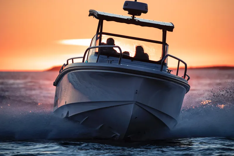Slide: The Image of Nimbus T8 2025 boat cruising at sunset. - 12