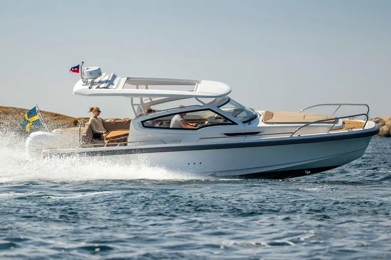 The Image of 2025 Nimbus W9 motorboat cruising on open water. - 0