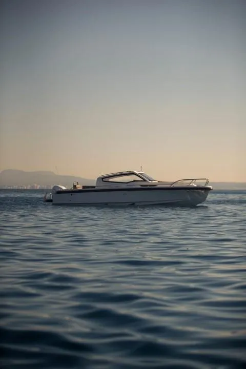 Slide: The Image of 2025 Nimbus W9 boat on calm water at sunset. - 10