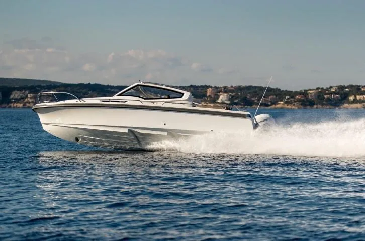 Slide: The Image of 2025 Nimbus W9 speedboat cruising on open water. - 19