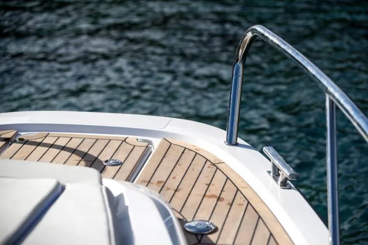 Slide: The Image of Nimbus W9 2025 boat deck with wooden flooring and metal railing. - 20