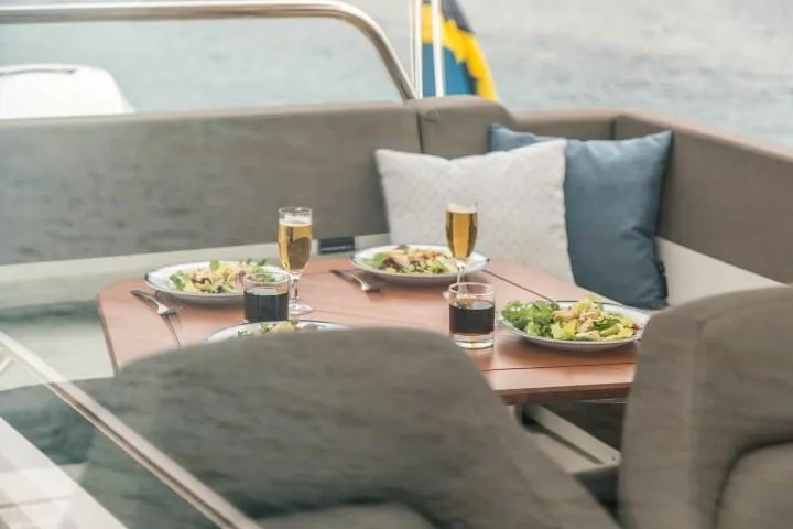 Slide: The Image of Dining setup on Nimbus W9 boat, 2025 model, with salads and drinks. - 32