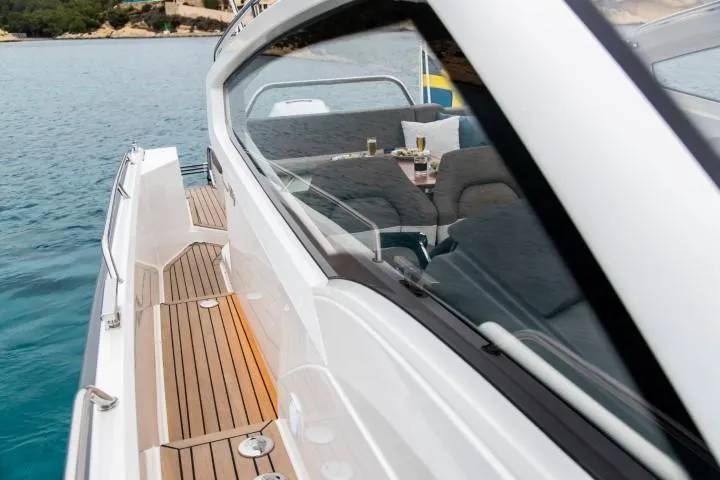 Slide: The Image of Nimbus W9 2025 model luxury yacht with teak deck and scenic ocean view. - 35
