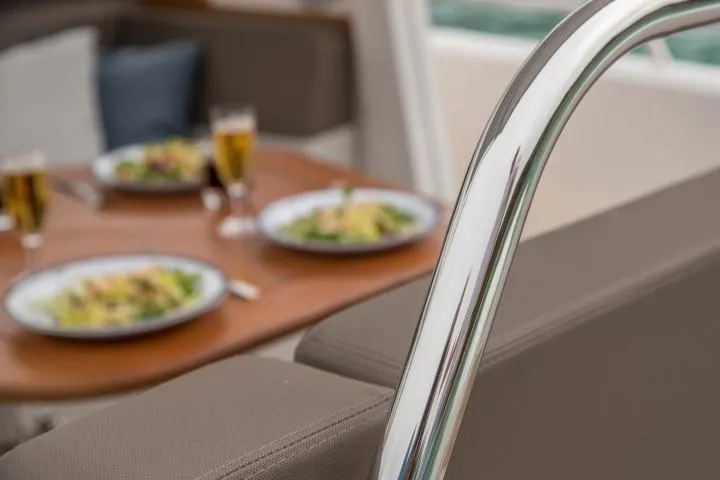 Slide: The Image of Dining area on Nimbus W9 boat, 2025 model, with plates of food and drinks. - 42