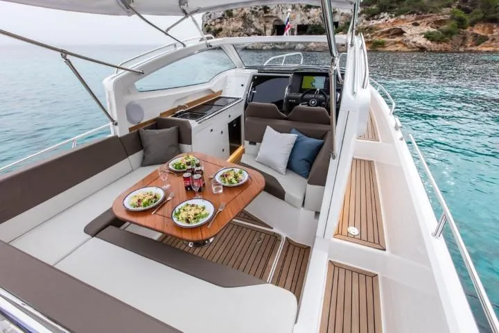 Slide: The Image of Luxurious 2025 Nimbus W9 yacht interior with dining setup on a serene sea. - 44